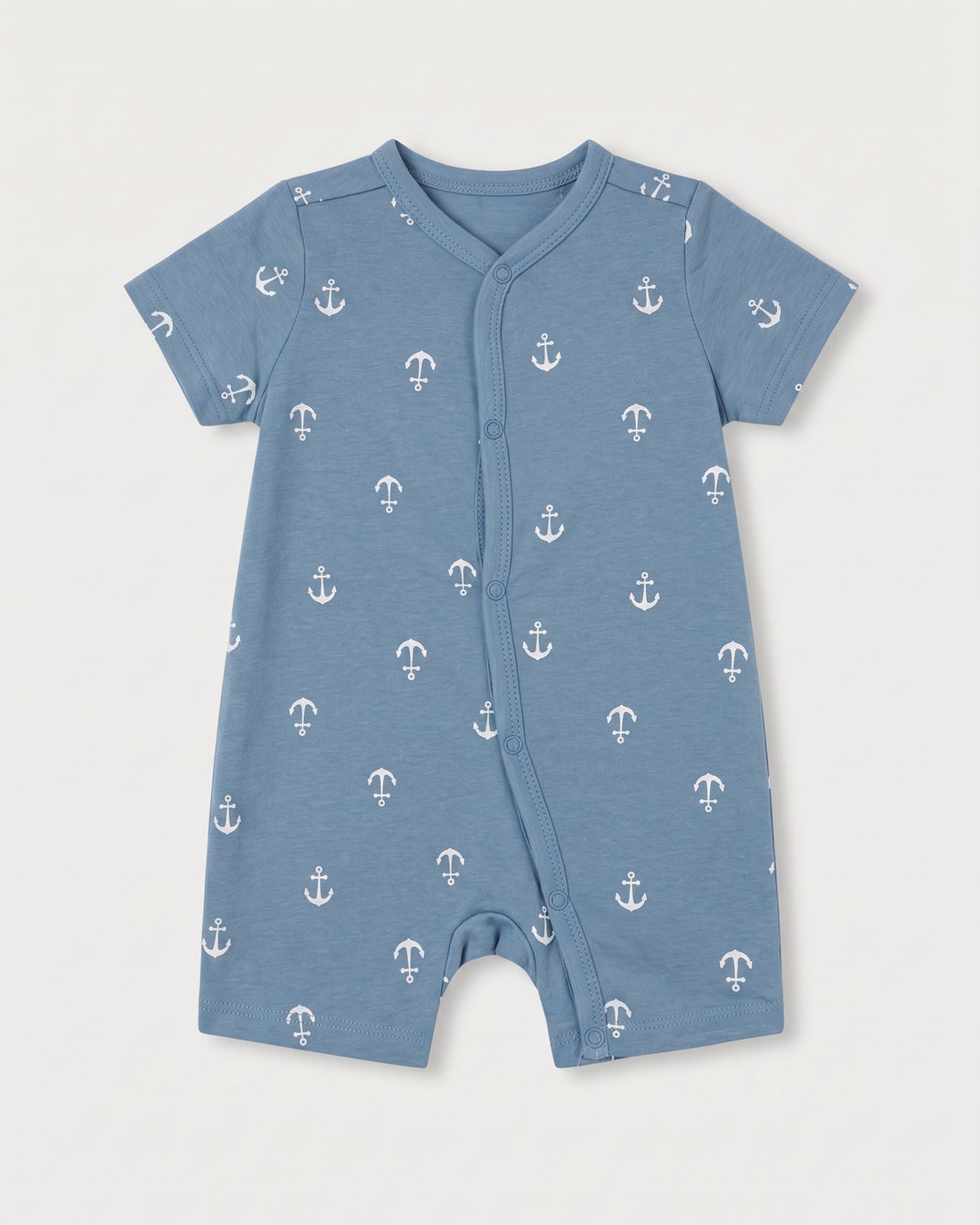 Steel blue baby jumpsuit with white nautical anchor print, short sleeves, and diagonal snap button front, flat lay on white background