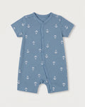 Steel blue baby jumpsuit with white nautical anchor print, short sleeves, and diagonal snap button front, flat lay on white background