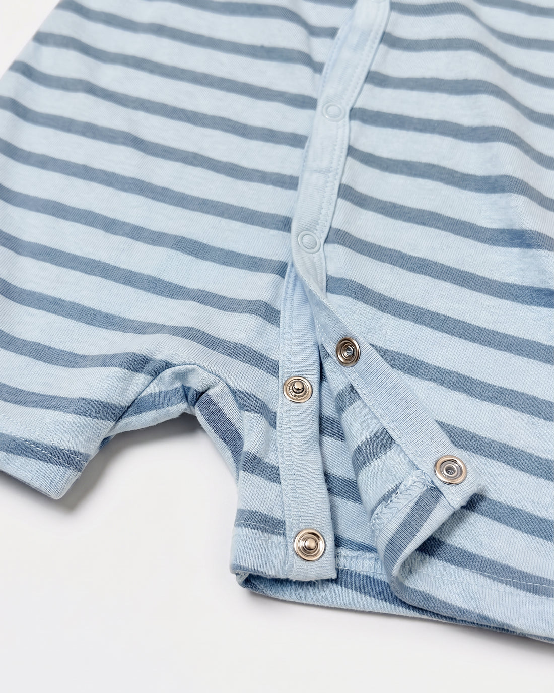 Dusky blue and slate stripe short-sleeve baby romper with diagonal snap button front, flat lay on white background