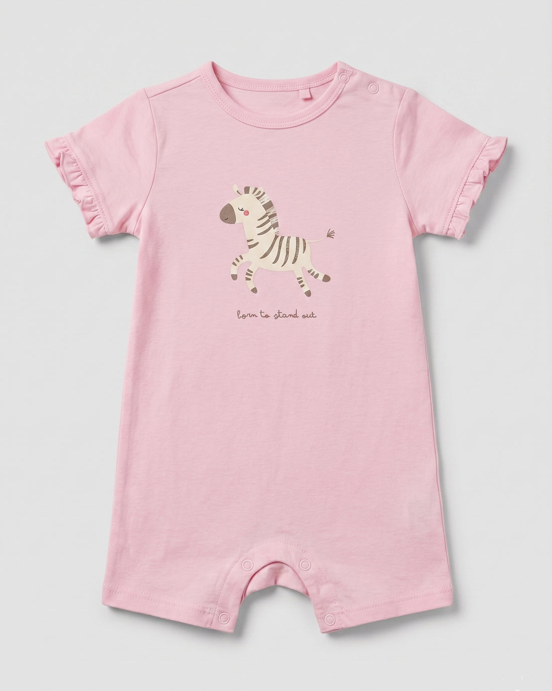 Blush pink baby girl romper with zebra graphic print, "born to stand out" slogan, and frill sleeves, flat lay on white background