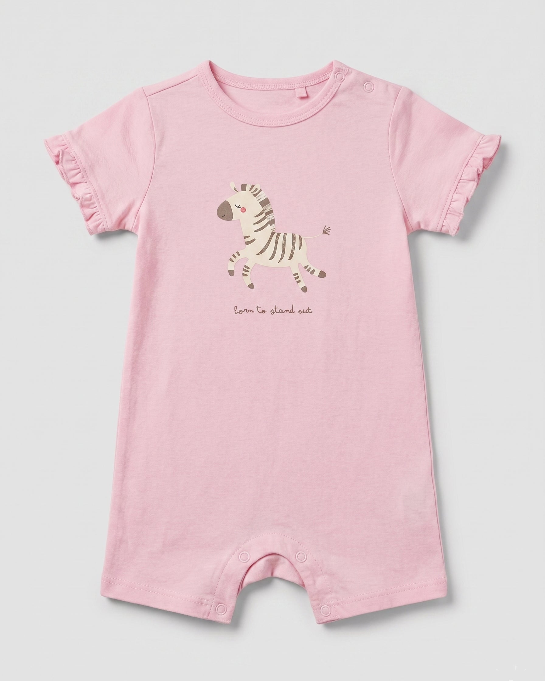Blush pink baby girl romper with zebra graphic print, "born to stand out" slogan, and frill sleeves, flat lay on white background