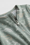 Close-up of sage green baby romper showing dinosaur print and two-way zipper detail