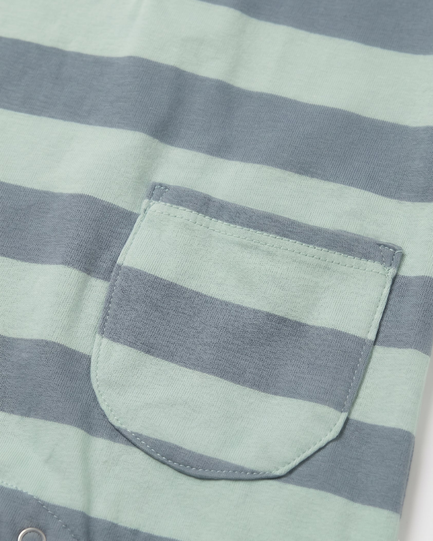 Close-up of front patch pocket on sage green and slate blue striped baby romper — PTex Fashion