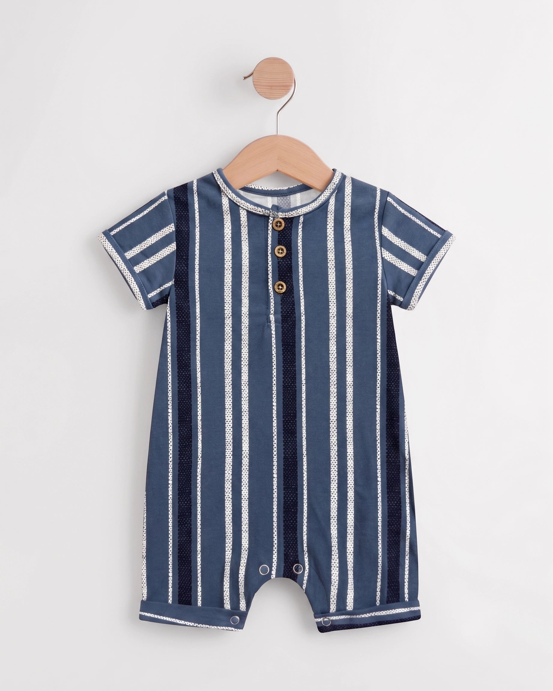 Blue striped baby romper on a wooden hanger showing button placket and leg press studs — PTex Fashion