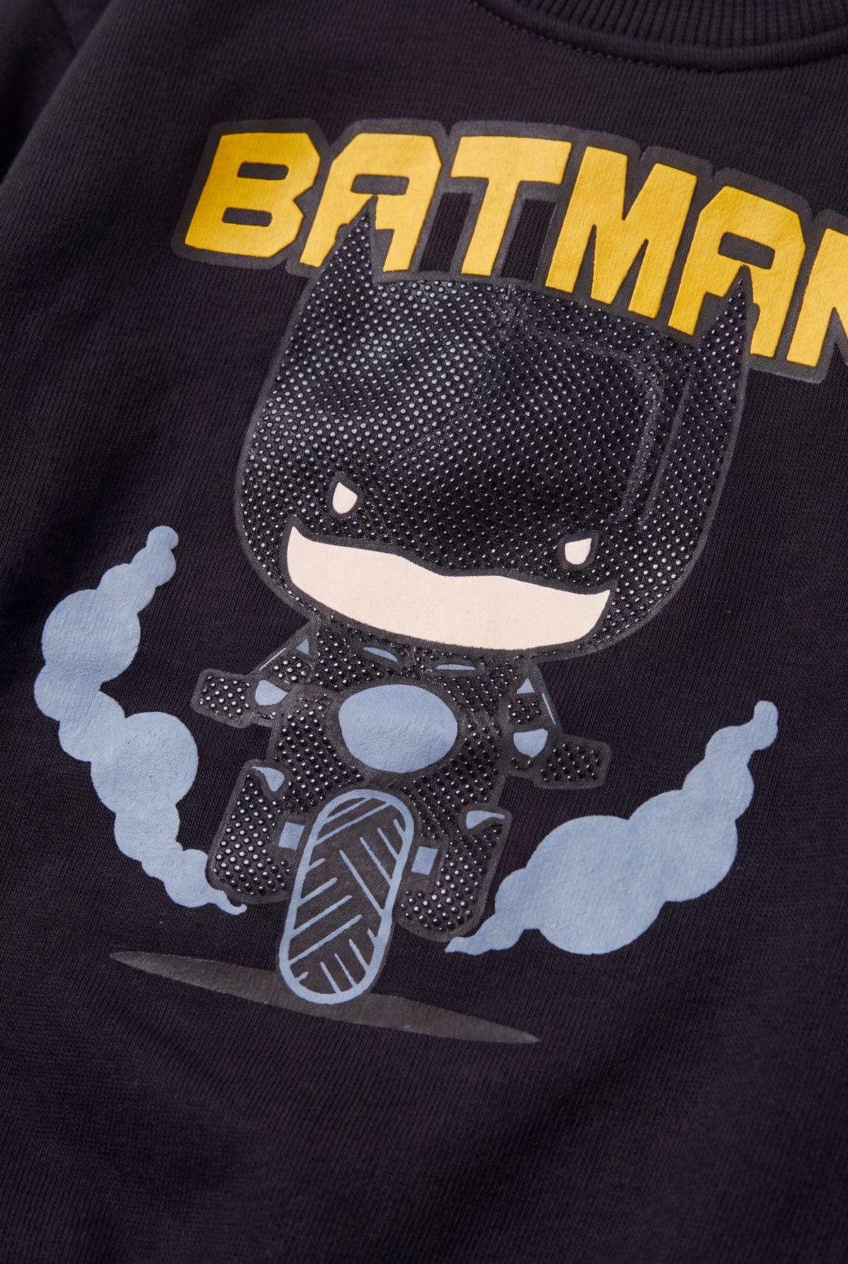 Close-up of raised dotted rubber print and blue smoke clouds on black sweatshirt – PTex Fashion