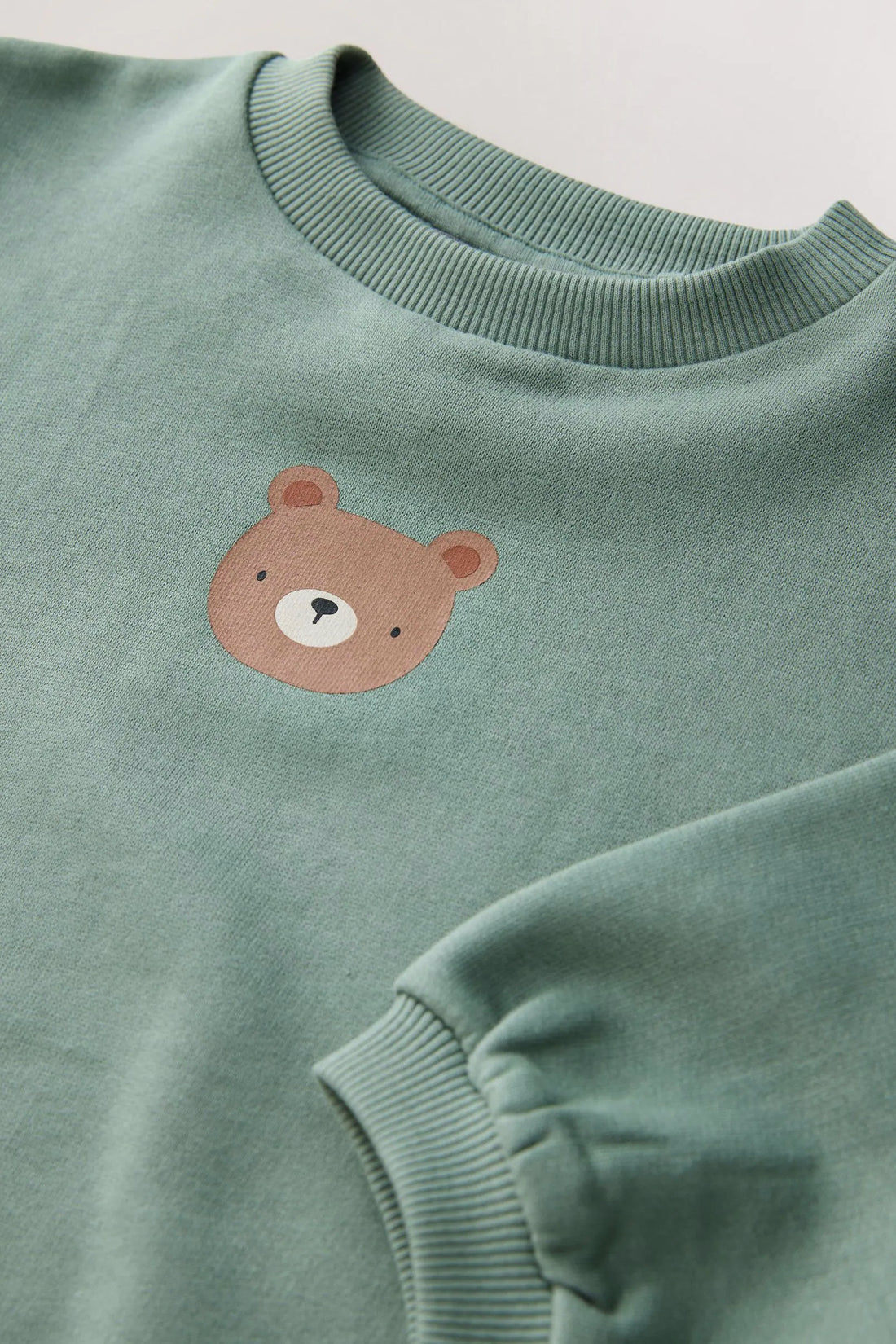 Baby toddler relaxed-fit sweatshirt with drop shoulders, ribbed neckline and cuffs, and small bear detail on the chest.