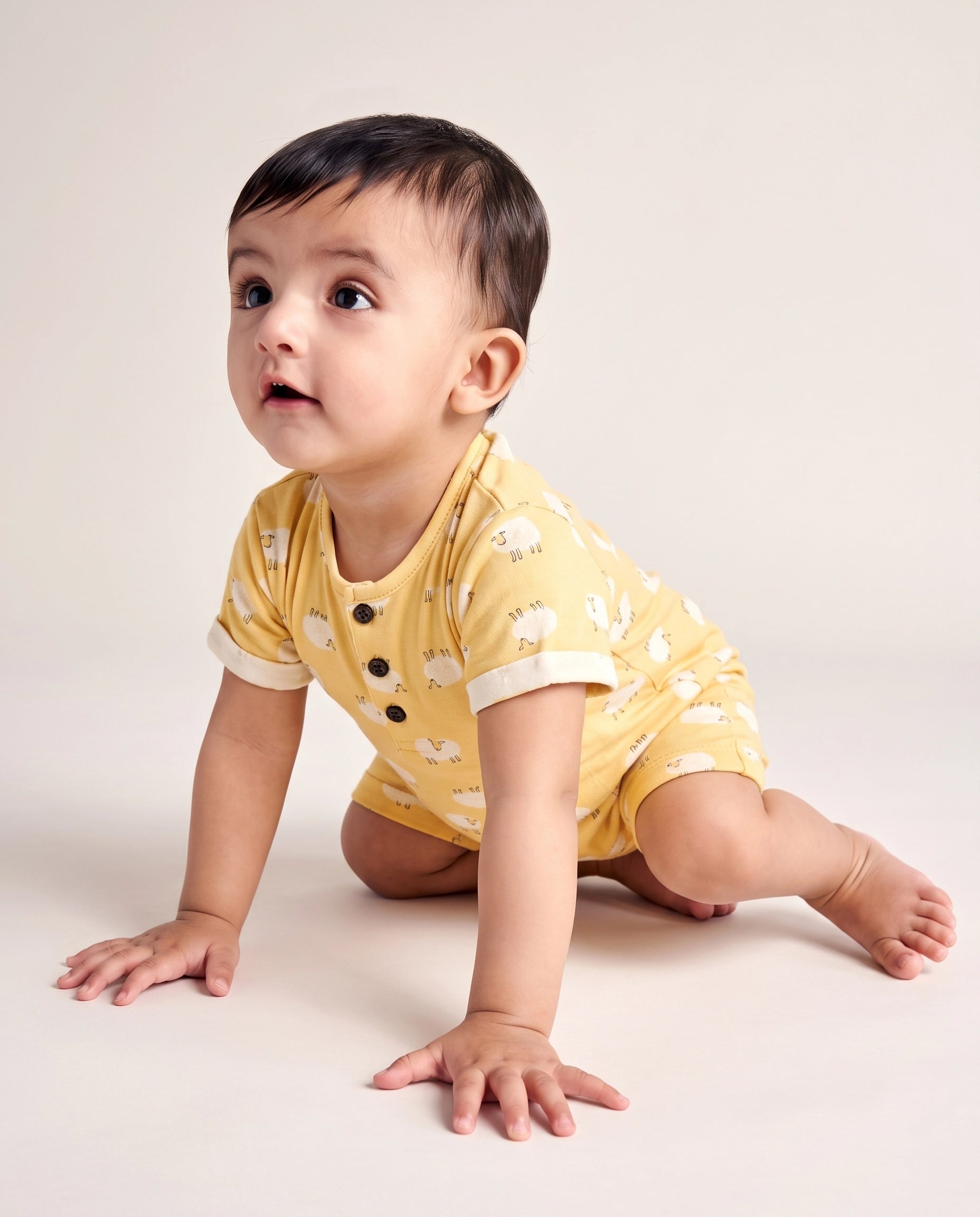 Baby crawling in yellow sheep print short sleeve cotton romper, front view — PTex Fashion