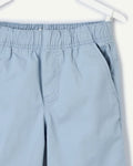  Close-up of elasticated pull-on waistband on sky blue boys' chino shorts, showing soft gathered cotton-blend twill and side pocket detail.