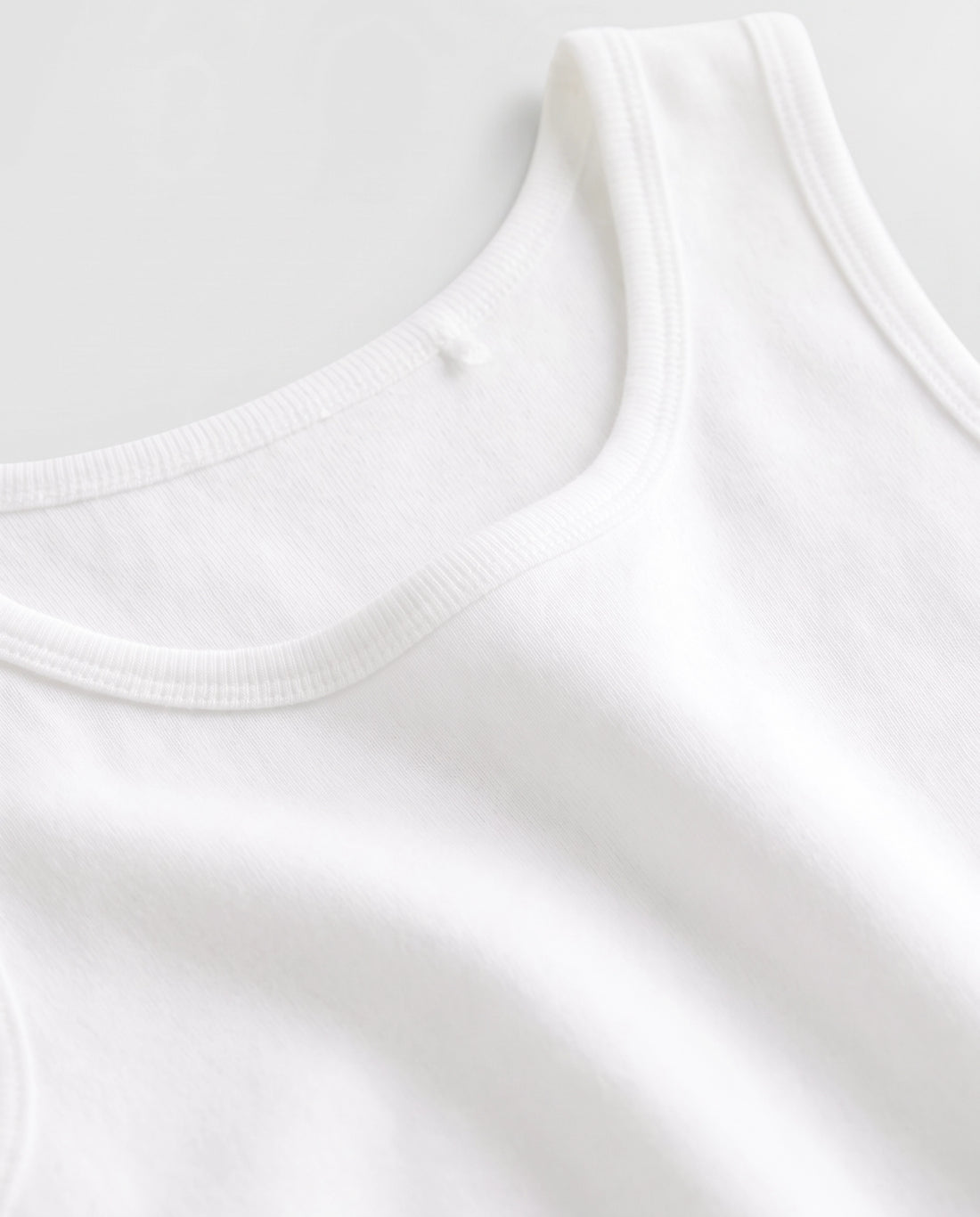 PTex Fashion boys' 4-pack white cotton sleeveless undershirt vest set for school, flat lay view