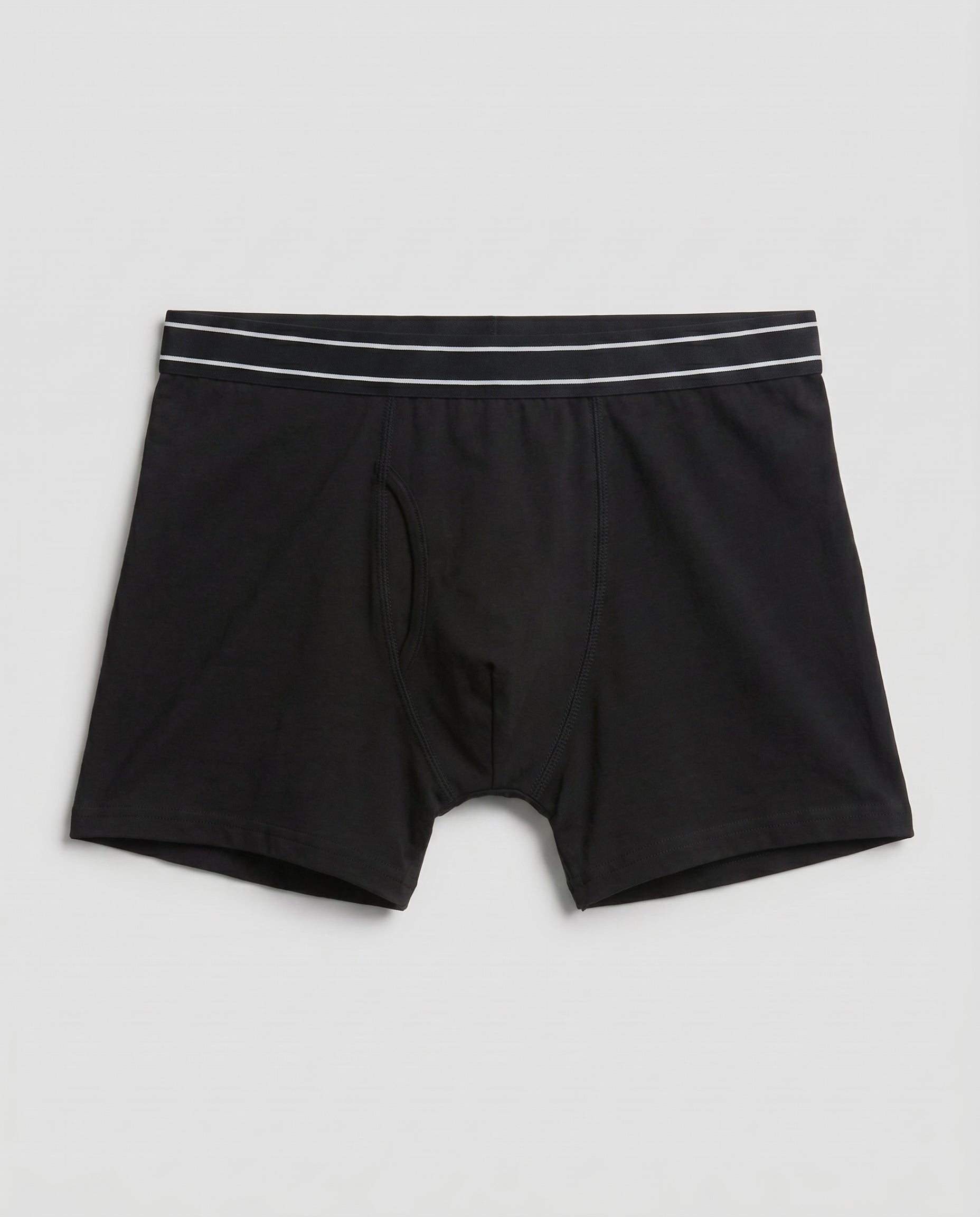 Boys' black soft cotton boxer brief with striped covered waistband, flat lay