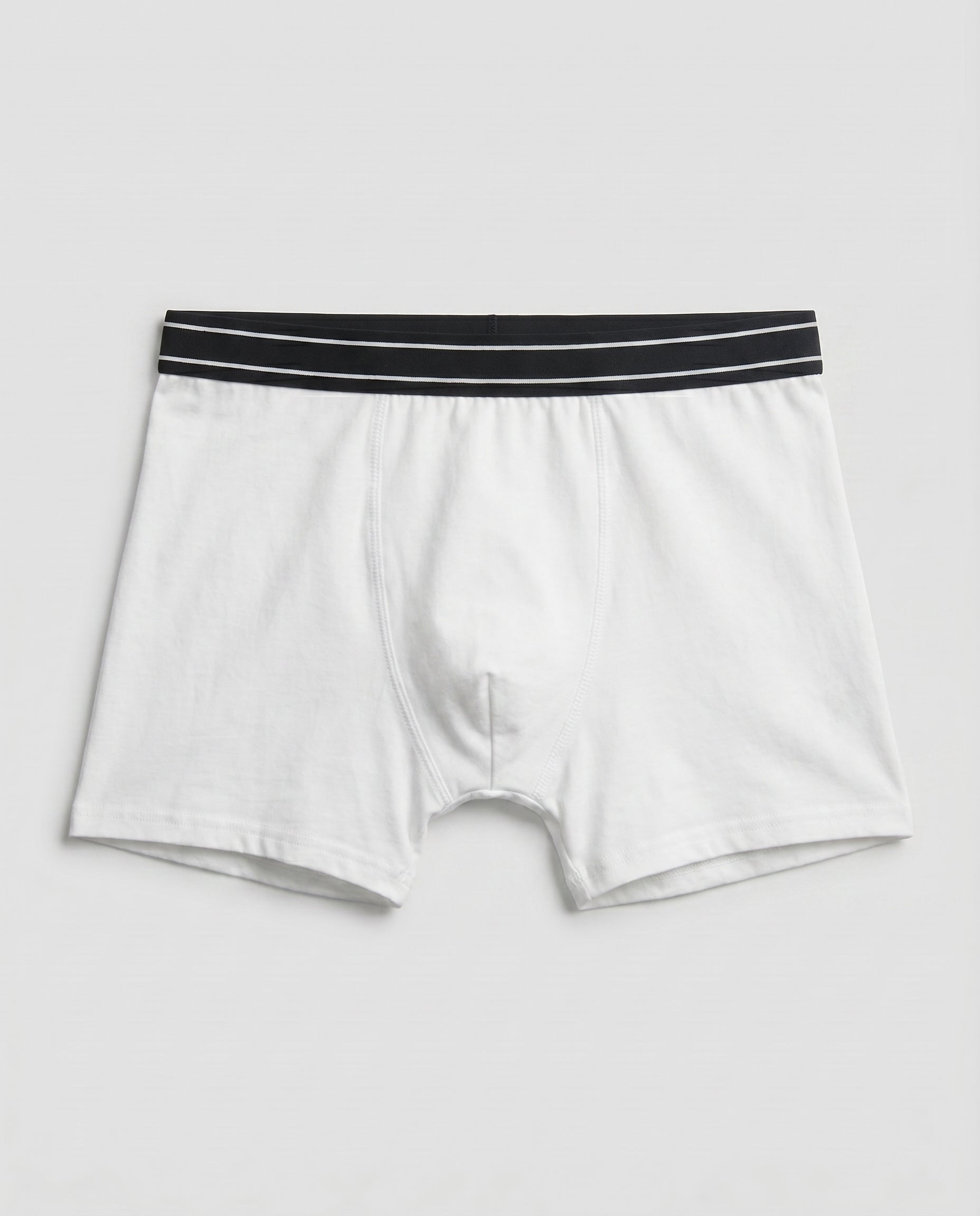 Boys' white cotton boxer brief with black striped waistband, flat lay