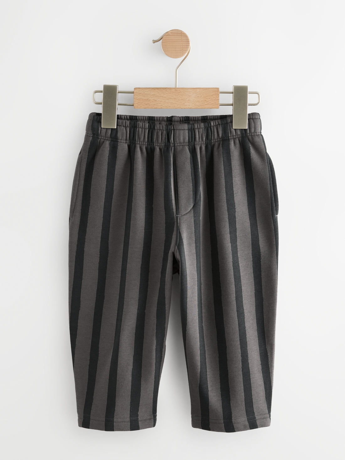 PTex Fashion charcoal and grey striped kids' trousers on a wooden hanger