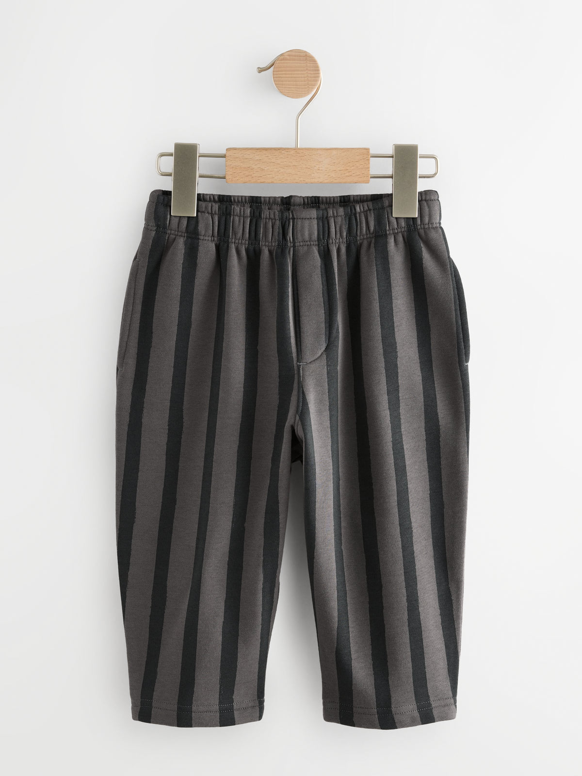 PTex Fashion charcoal and grey striped kids' trousers on a wooden hanger