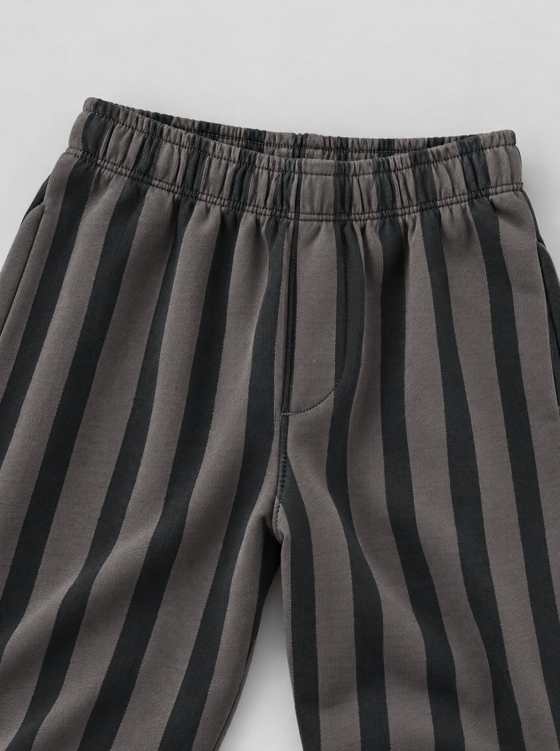 PTex Fashion charcoal and grey striped kids' trousers on a wooden hanger