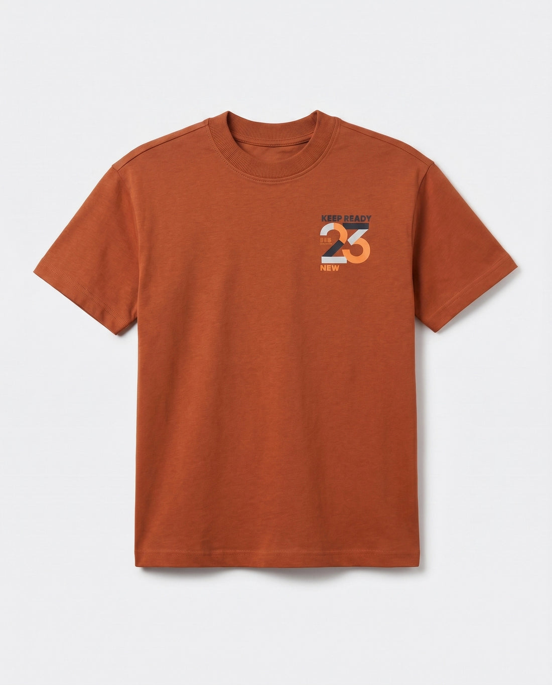 Front view of boys' rust orange crew neck cotton t-shirt with small "Keep Ready 23" chest logo and short sleeves