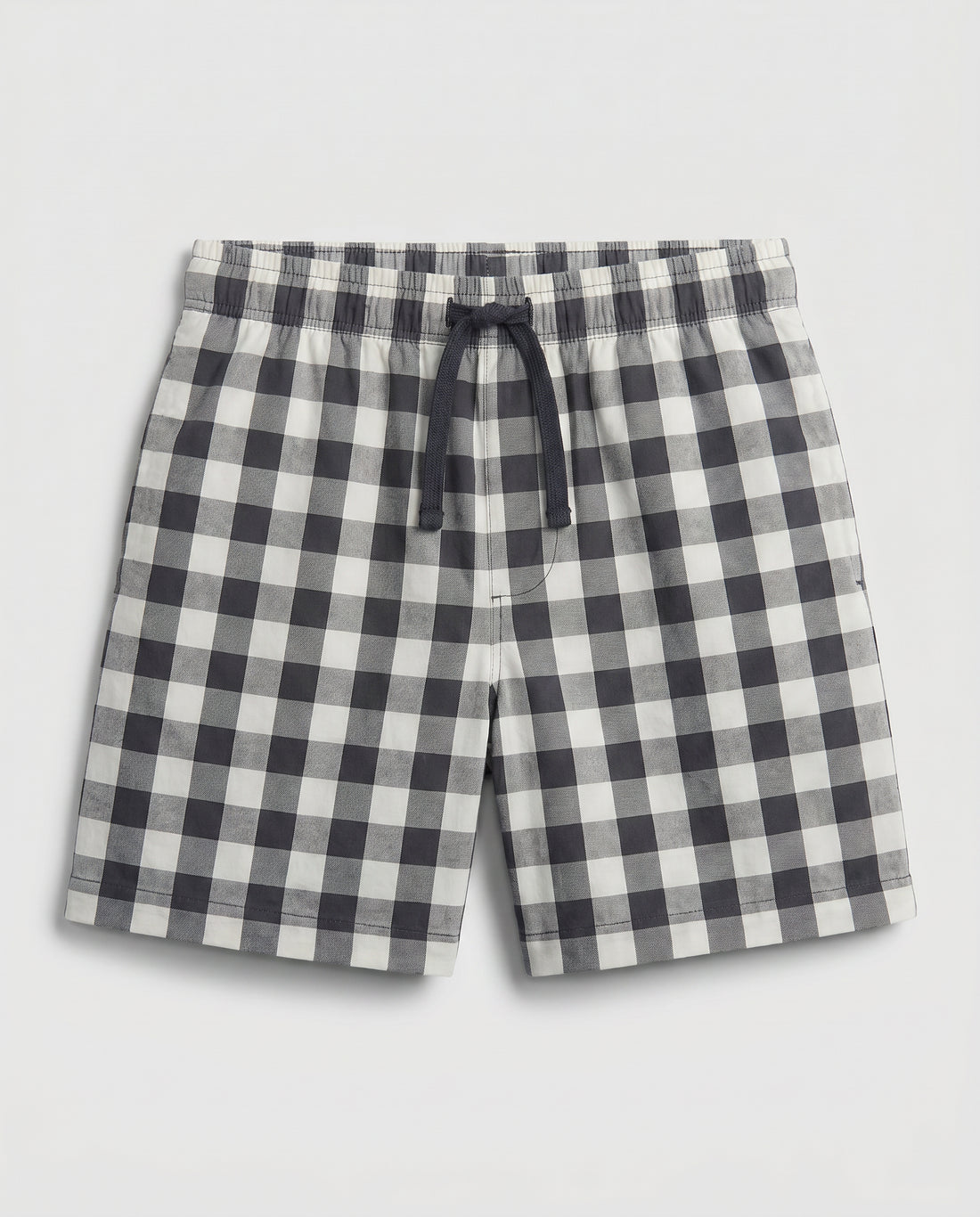 Boys' woven cotton pull-on short pant in navy and off-white block check with adjustable drawstring waist, flat lay product photo