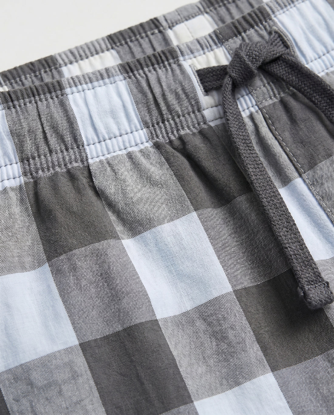  Boys' woven cotton pull-on short pant in grey and white block check with adjustable drawstring waist, flat lay product photo