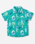 Flat lay of a PTex Fashion green remi cotton shirt for boys with palm tree and surfboard print