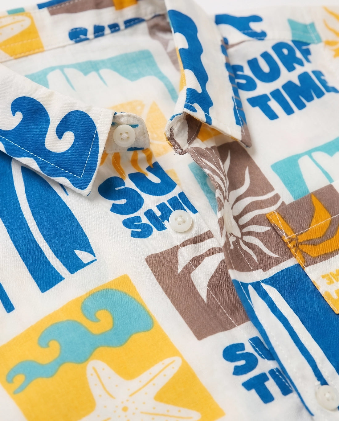 Flat lay of a PTex Fashion off-white boys' shirt with retro surf and sunshine print