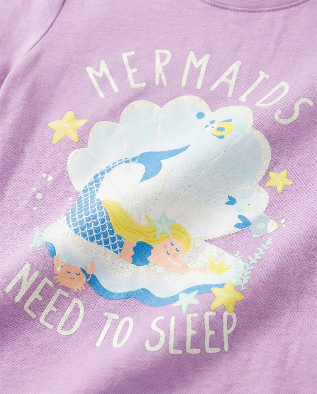 Close-up of sleepy mermaid, crab, starfish and seashell glitter print on purple girls' cotton tee