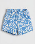 Front flat-lay view of girl's white short pant with all-over blue botanical folk floral print and ruched paperbag elasticated waistband