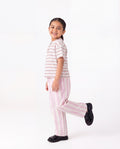 Child wearing pink and white striped pajamas on a white background