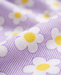 Close-up of PTex Fashion girls' cotton set fabric showing lilac pinstripe with white daisy and yellow floral print