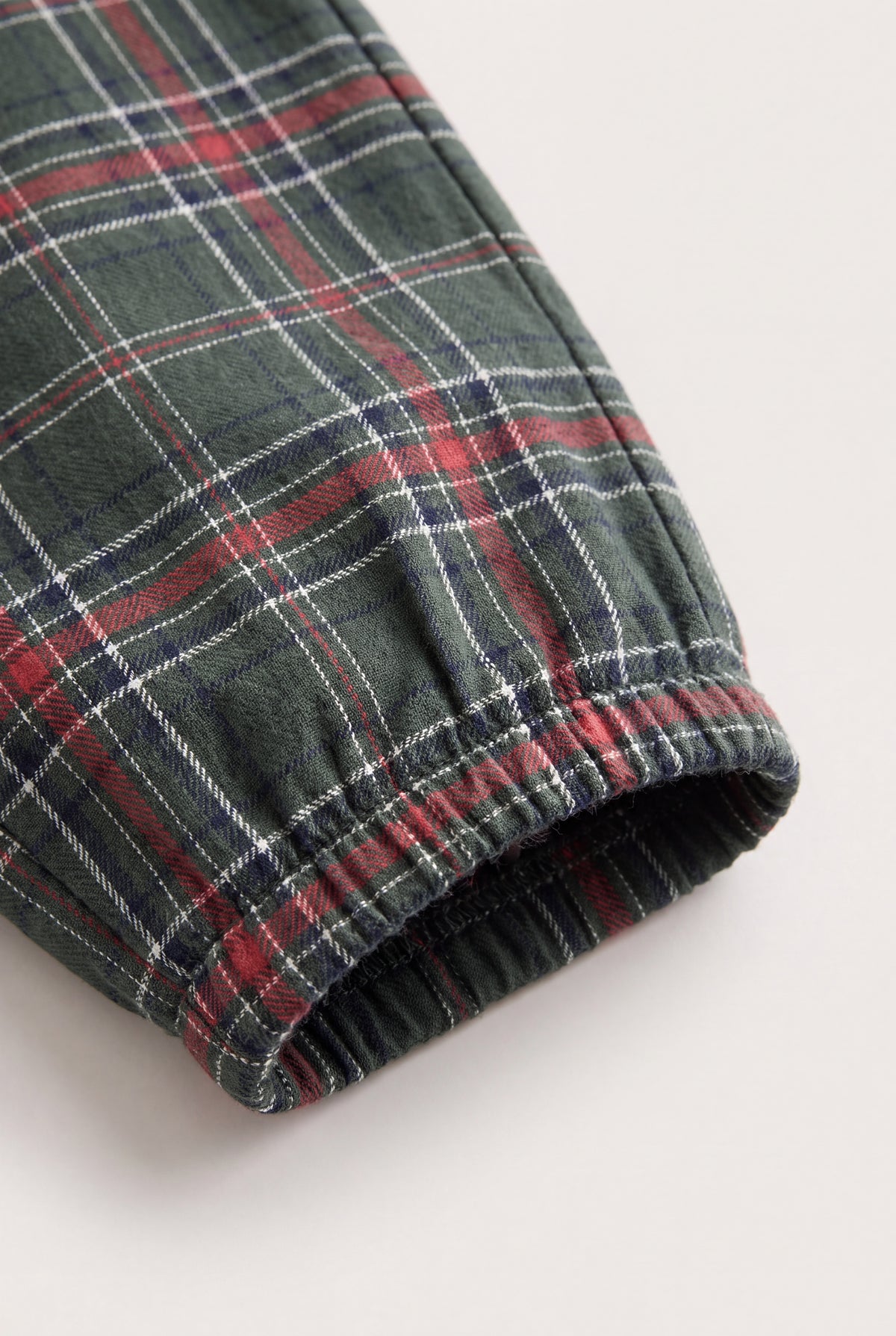 Cuff close-up: PTex Fashion girls' green check cotton trousers elasticated cuff detail