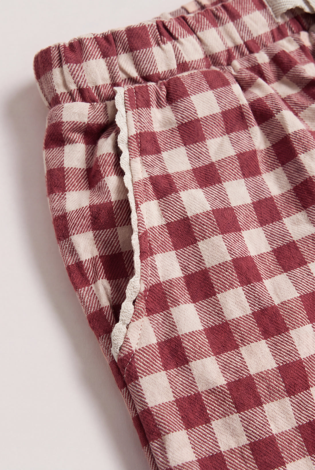 Hanger flat shot: PTex Fashion girls' berry and cream gingham cotton pull-on trousers with cuffed hem