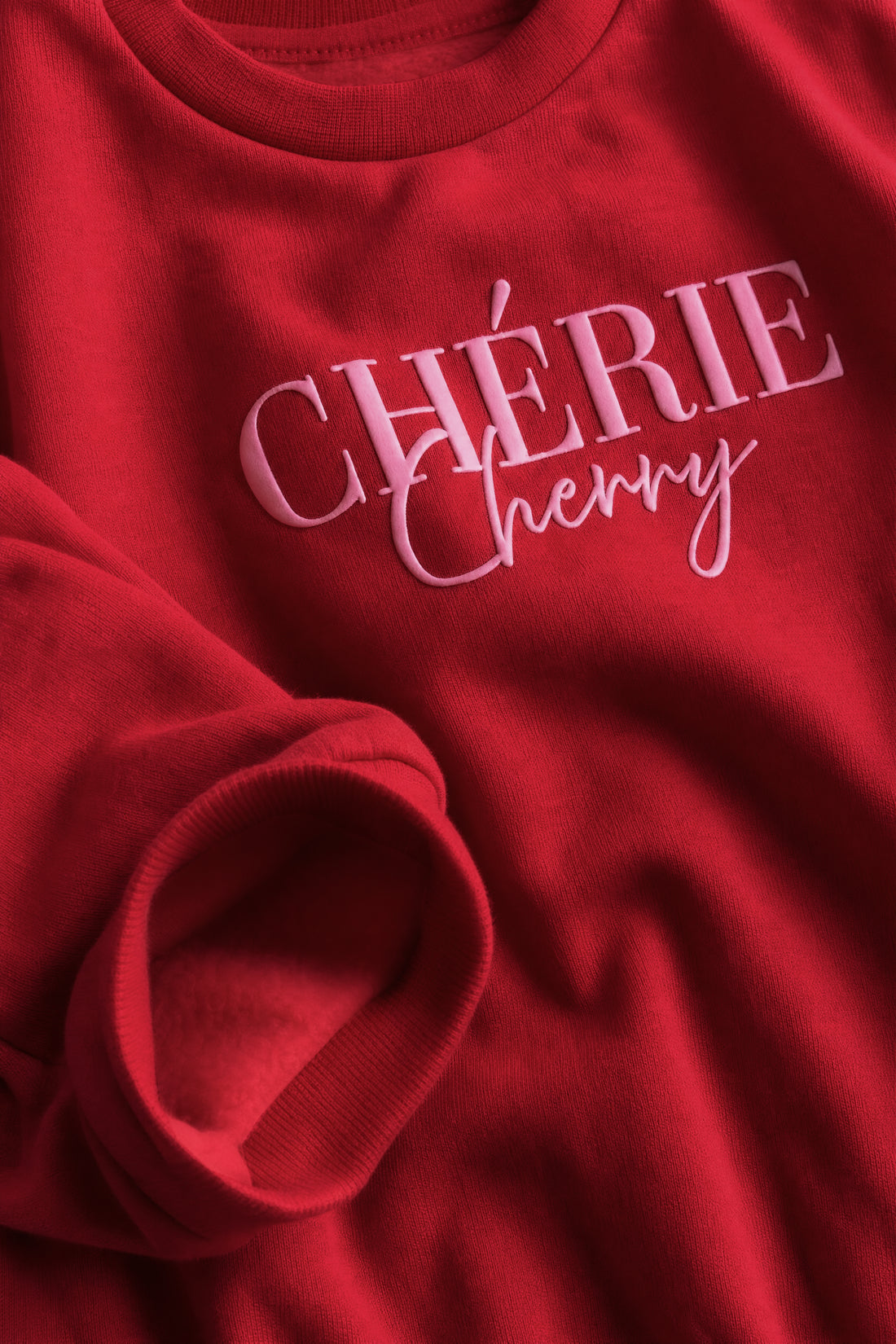Girls’ Chérie Cherry puff print fleece sweatshirt with drop shoulders, ribbed crew neck, cuffs and hem.