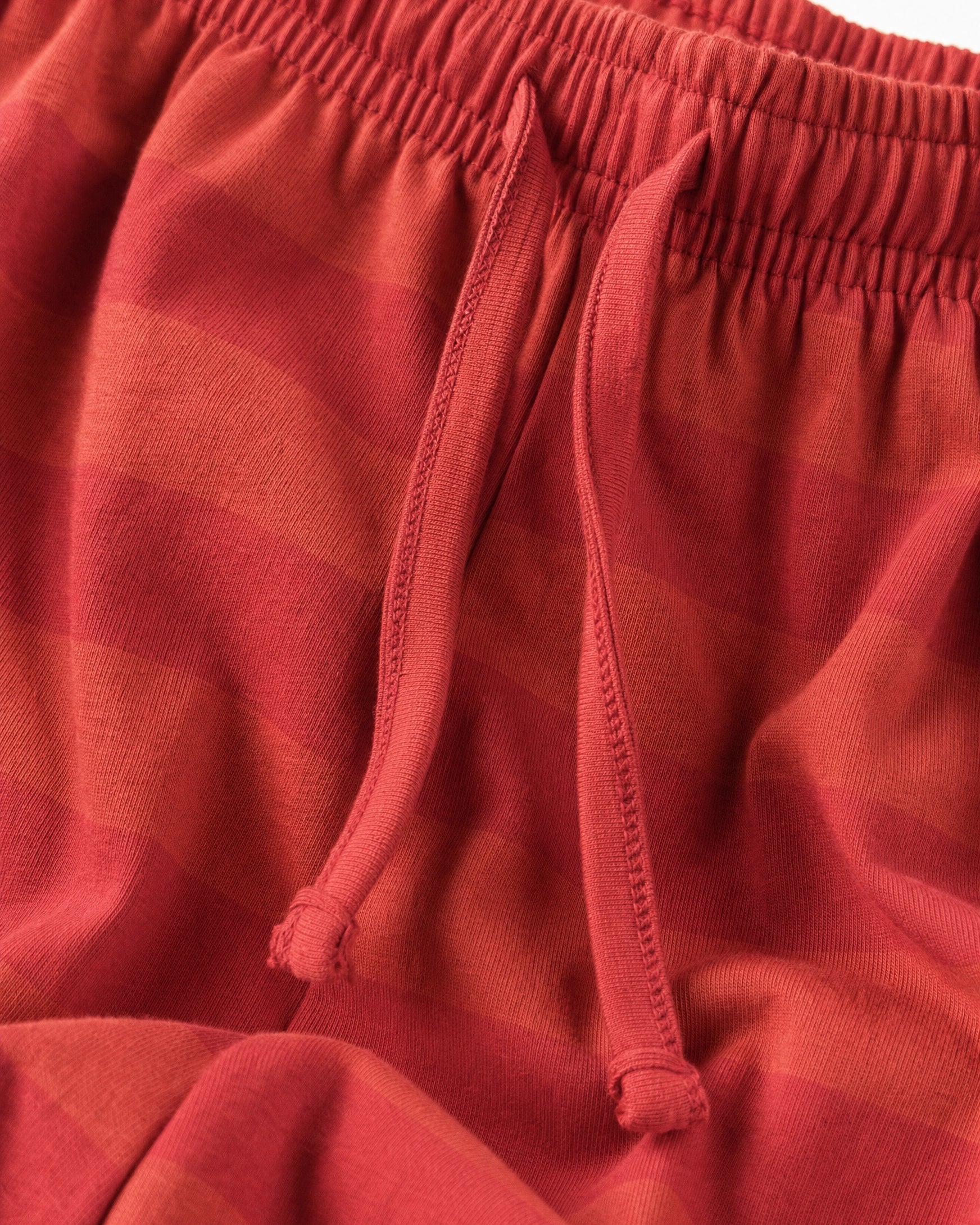Close-up of girls’ soft cotton red striped palazzo trousers with elastic waistband and drawstring