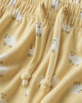 Close-up of girls’ soft cotton yellow palazzo trousers with sheep print and adjustable drawstring
