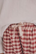 On-model waist detail: PTex Fashion girls' gingham woven trousers with elastic waistband and cream tie bow