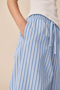 Close-up of girl wearing blue and white striped cotton pants with elastic waist and side pocket