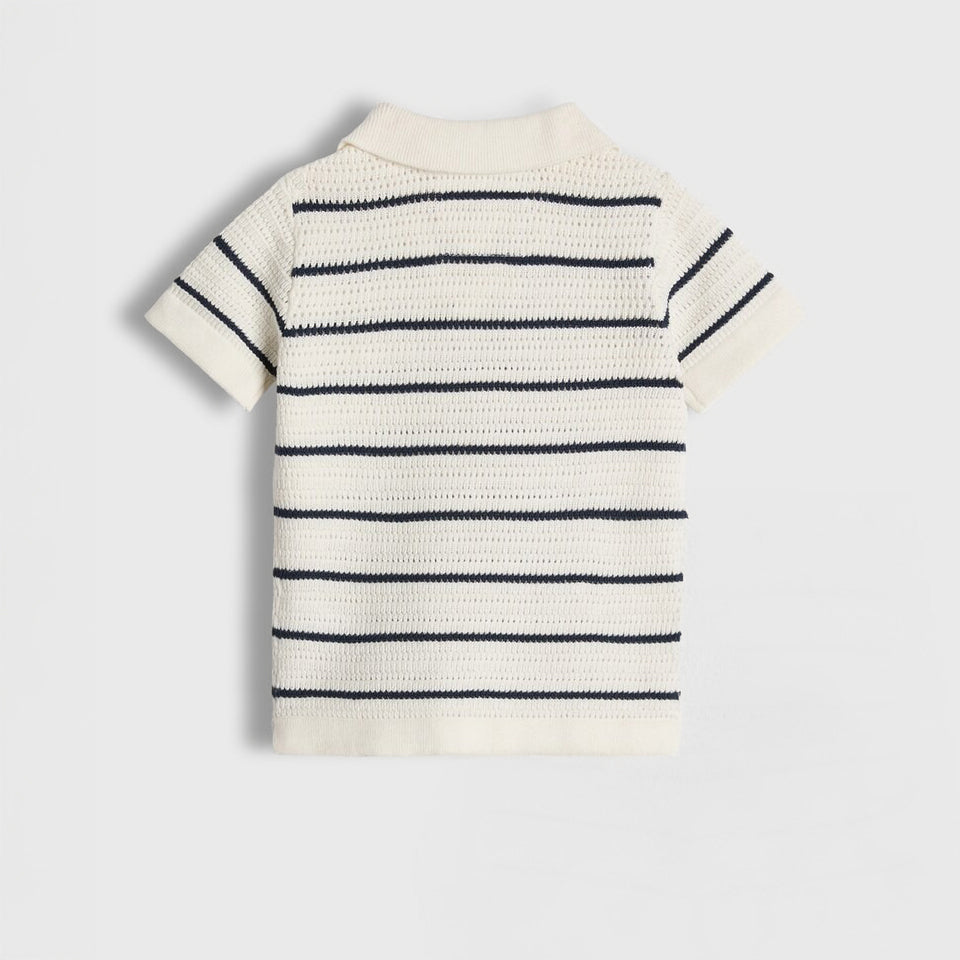 Striped polo shirt on a light gray background