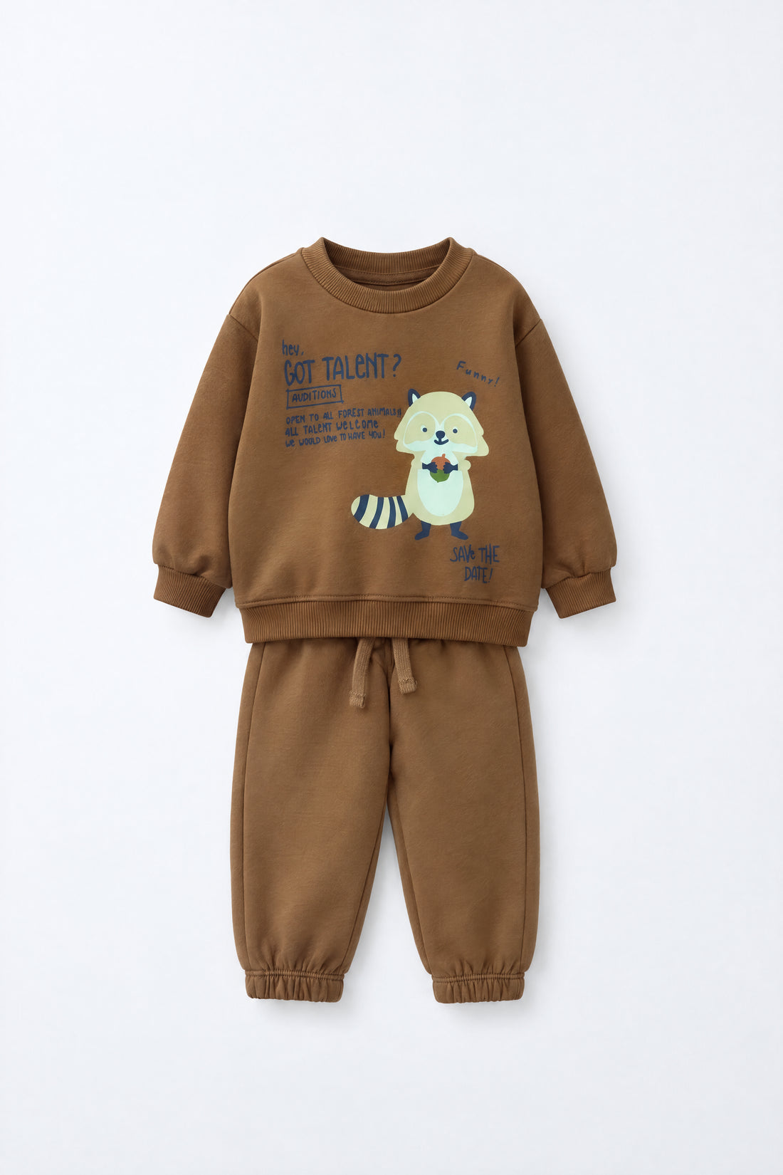 Baby wearing a brown sweatshirt and jogger set with raccoon graphic, elasticated waistband and relaxed infant-friendly fit.