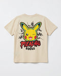Flat lay showing the back of a cream boys' t-shirt with a large Pikachu street-art style graphic, zigzag electric bolt lines, and graffiti text