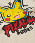 Close-up of the back print on a cream kids' t-shirt showing a winking Pikachu character face with red graffiti lettering and #0025 text