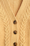 PTex Fashion girls’ mustard yellow chenille cardigan close-up showing braided cable knit, ribbed V-neck and tortoiseshell-effect buttons