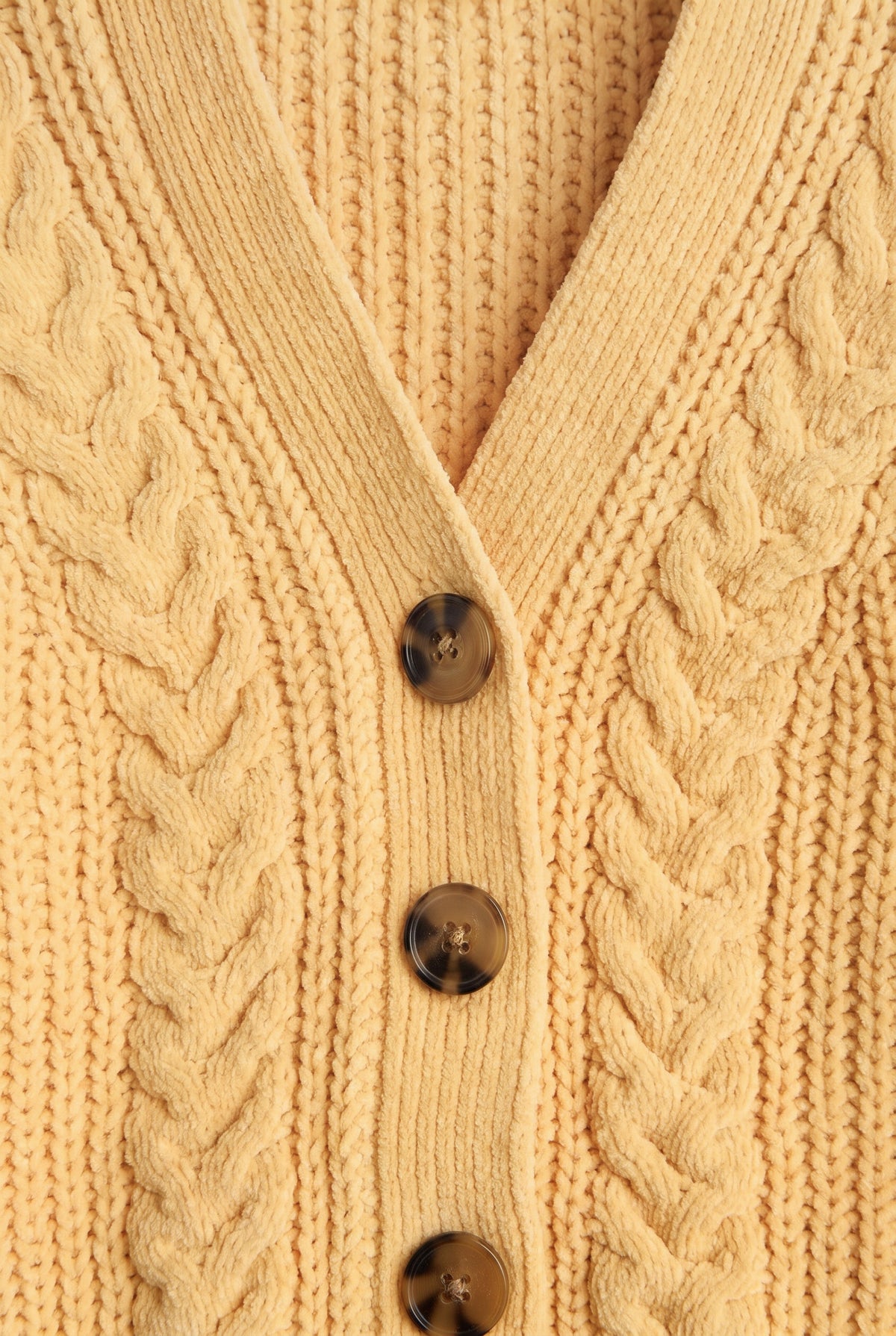 PTex Fashion girls’ mustard yellow chenille cardigan close-up showing braided cable knit, ribbed V-neck and tortoiseshell-effect buttons