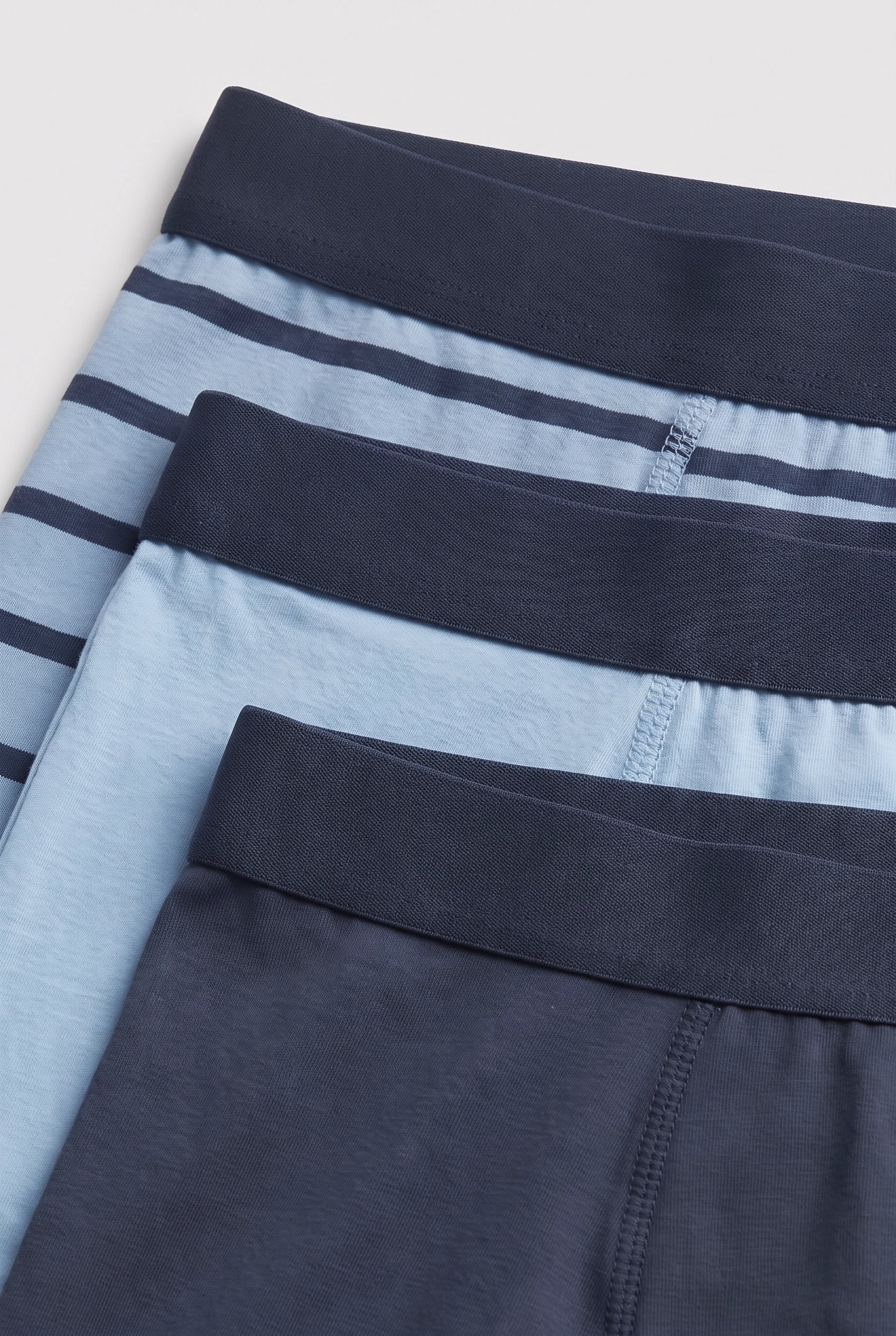 PTex Fashion boys' 3-pack cotton boxer briefs close-up showing navy covered elastic waistbands and flat seam stitching in navy stripe, light blue and slate blue