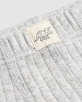 Close-up of grey marl ribbed fabric with woven triceratops dinosaur label on boys' boxer briefs
