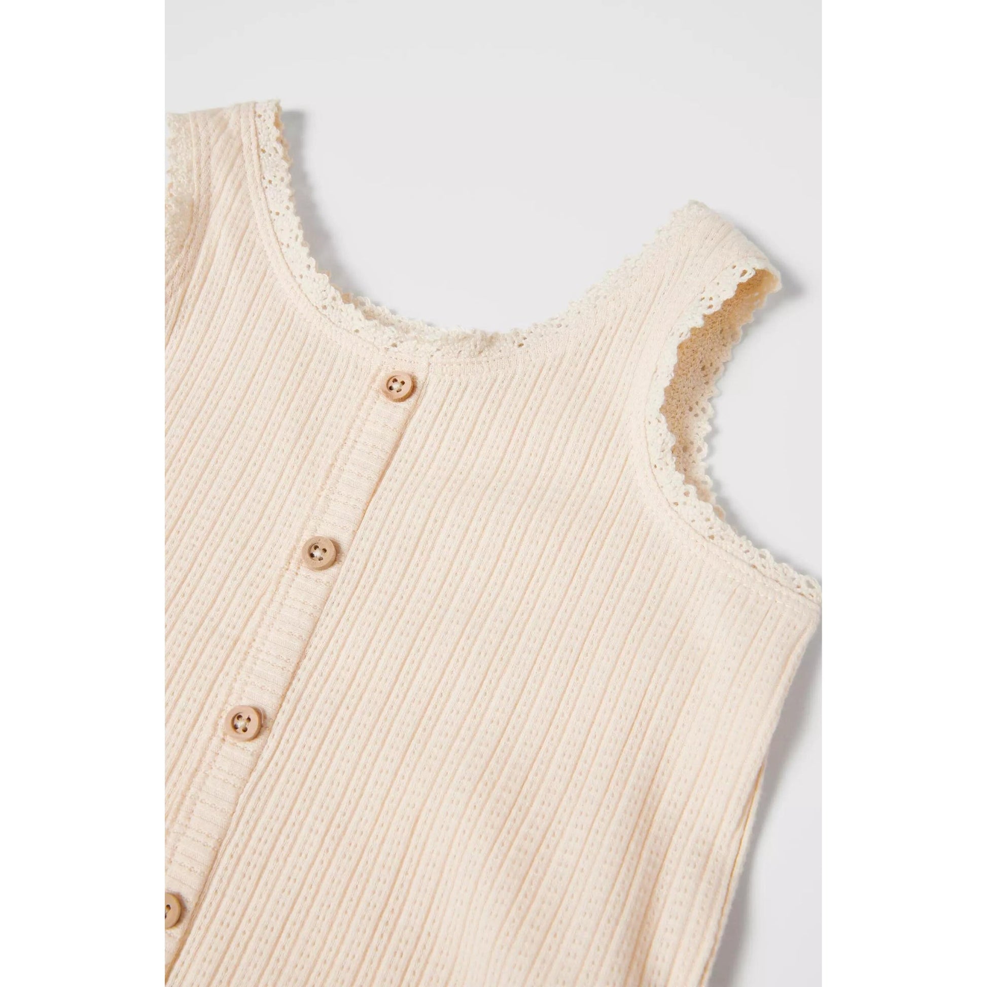 Sleeveless open knit top with a round neck