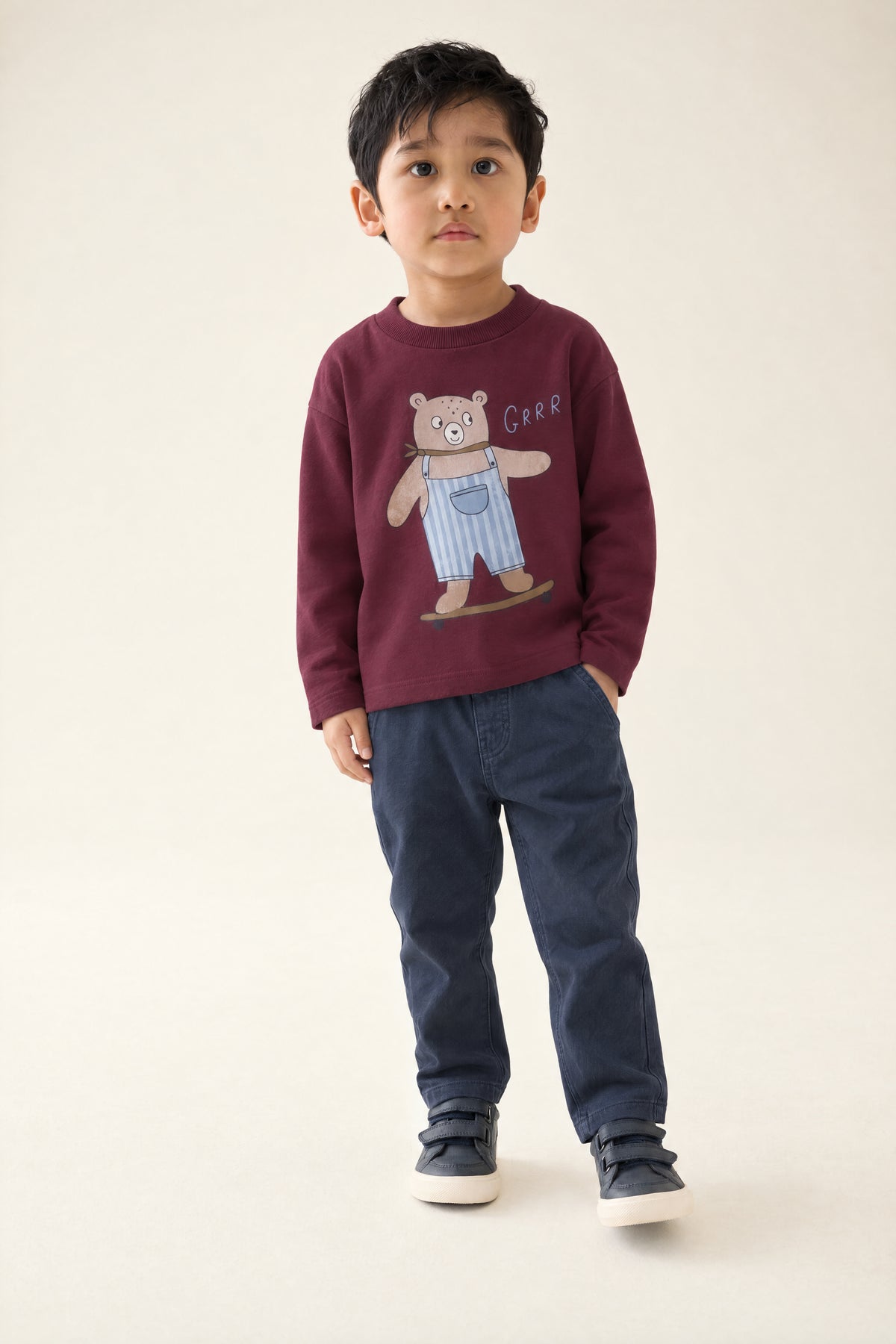 PTex Fashion boy wearing a burgundy skating bear long sleeve t-shirt with navy chinos