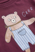 PTex Fashion close-up of the bear in striped dungarees print and ribbed collar on a burgundy t-shirt