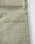Close-up of back patch pocket on sage green boys' denim Bermuda shorts, showing contrast topstitching detail and soft washed cotton denim texture.