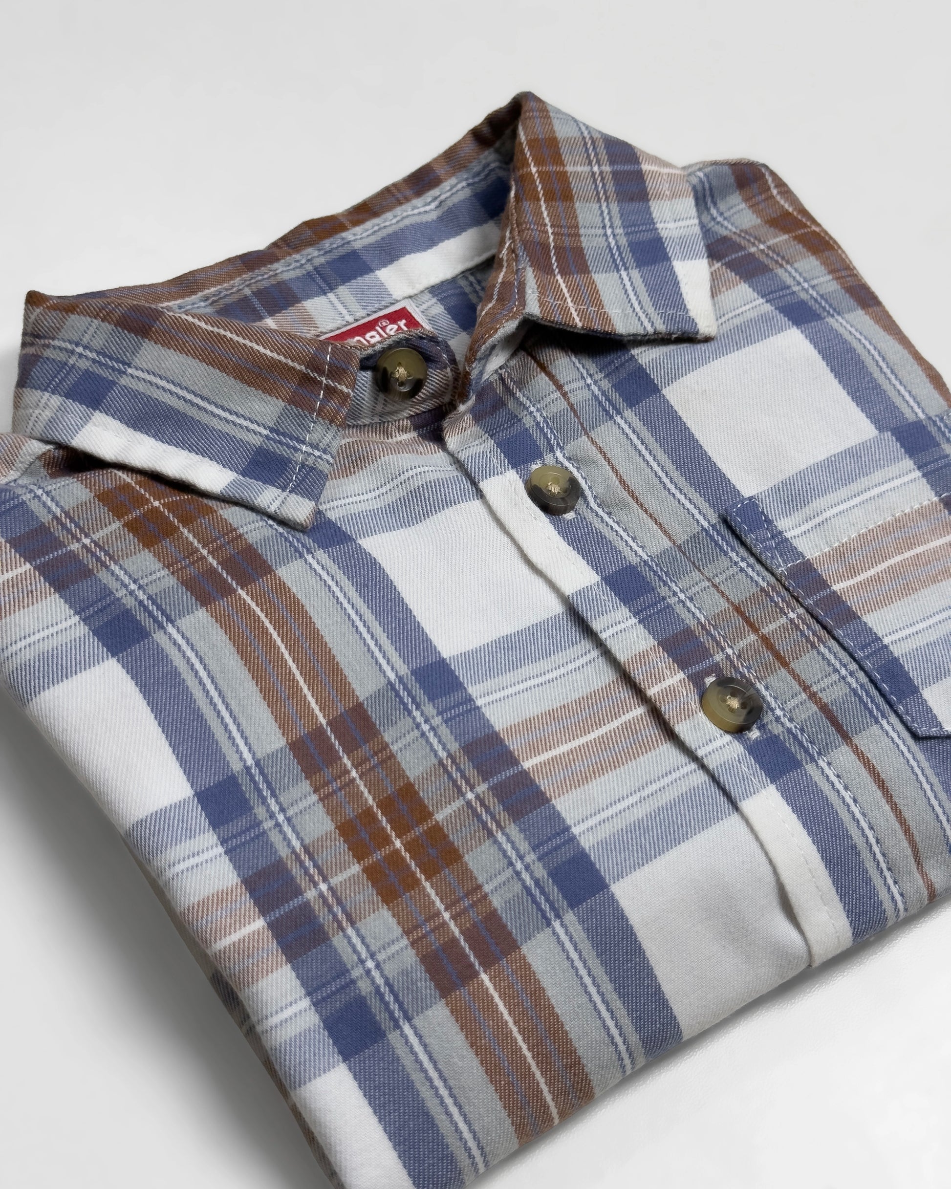 Plaid toddler shirt against a white background