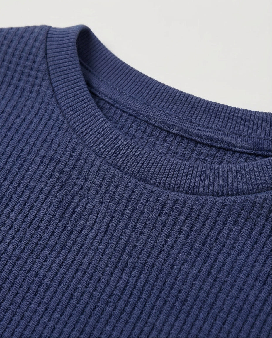 Full flat lay front view:
Toddler drop shoulder waffle knit t-shirt in navy blue displayed flat lay on a white background, showing a relaxed boxy fit, ribbed crew neckline, short sleeves with ribbed cuffs, and a single chest patch pocket.