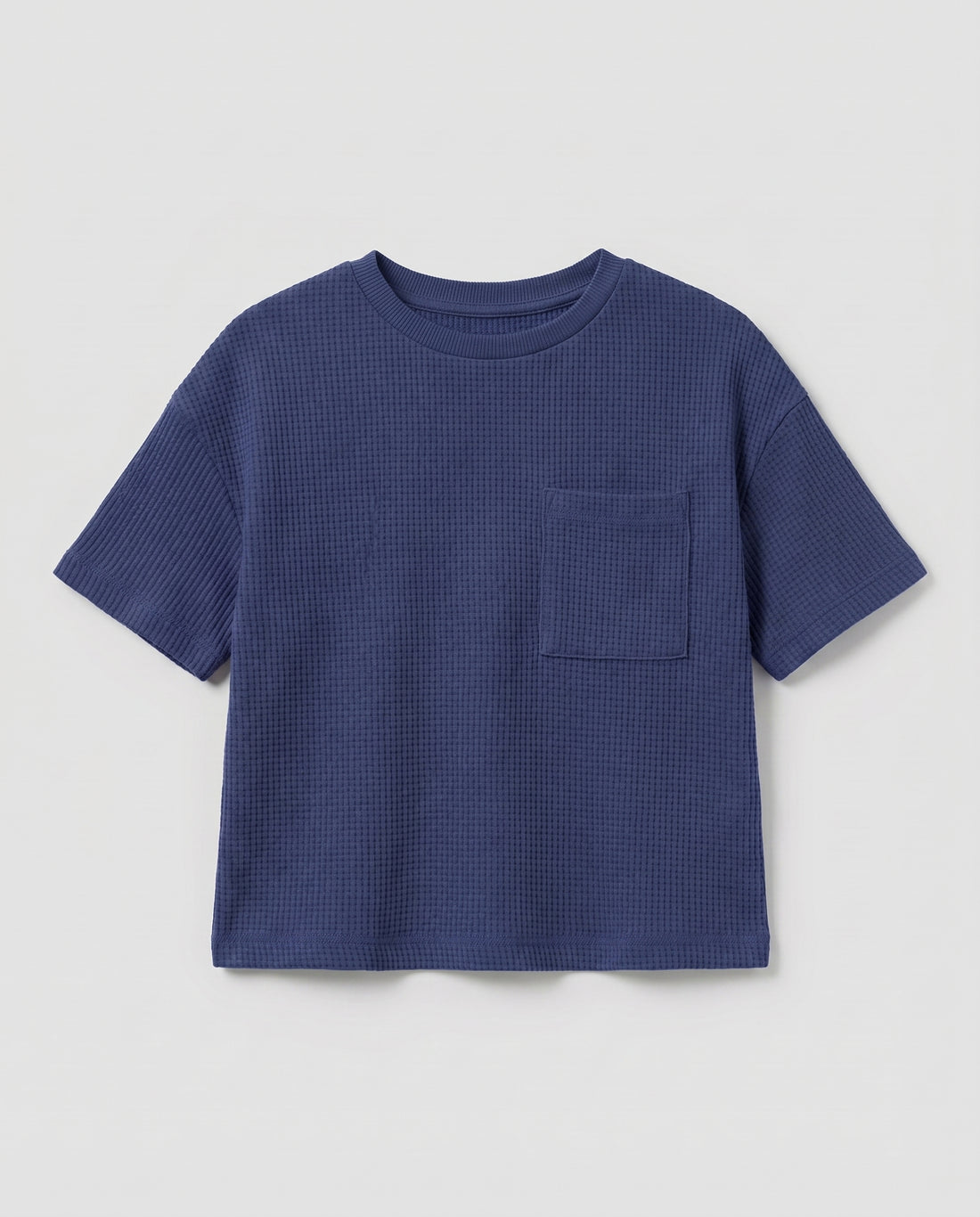 Full flat lay front view:
Toddler drop shoulder waffle knit t-shirt in navy blue displayed flat lay on a white background, showing a relaxed boxy fit, ribbed crew neckline, short sleeves with ribbed cuffs, and a single chest patch pocket.