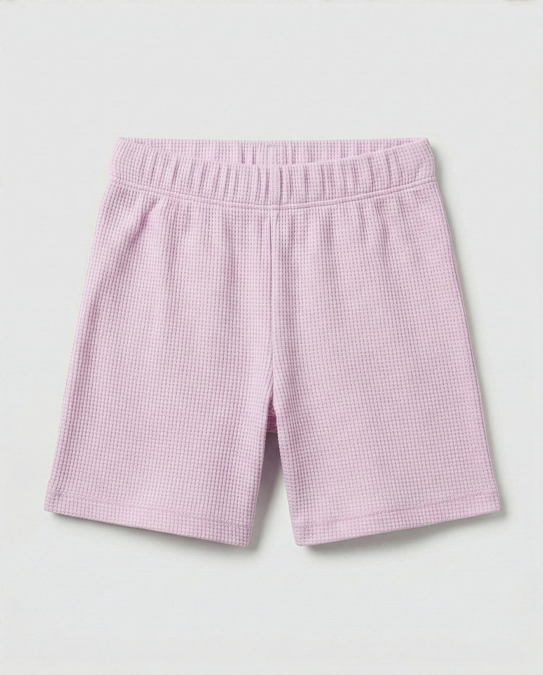 Toddler girls' waffle-knit cotton short pants in pink lilac with a wide elasticated waistband, laid flat on a light grey background.